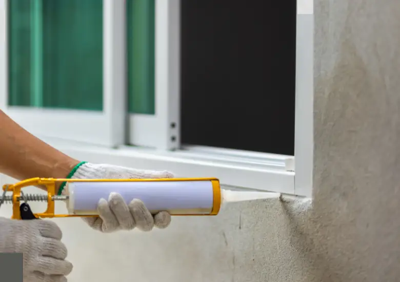 a man put the glue in Aluminium Window